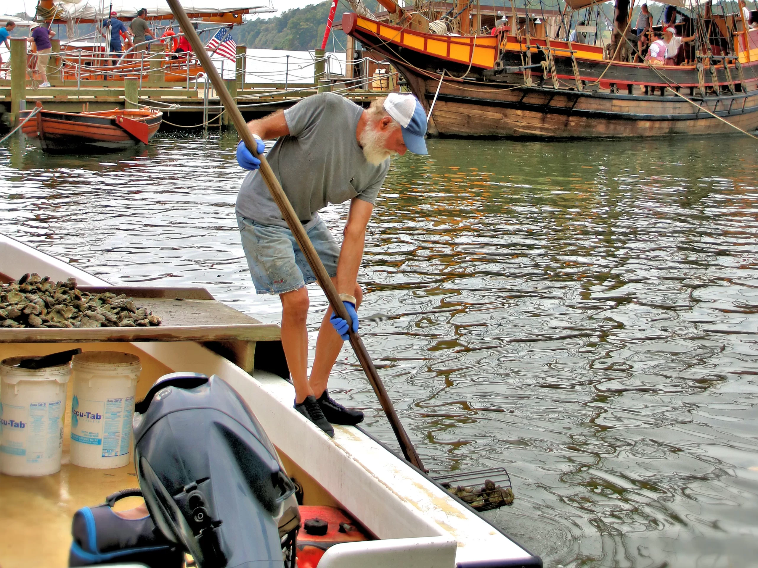 White rain barrell filling a watering can